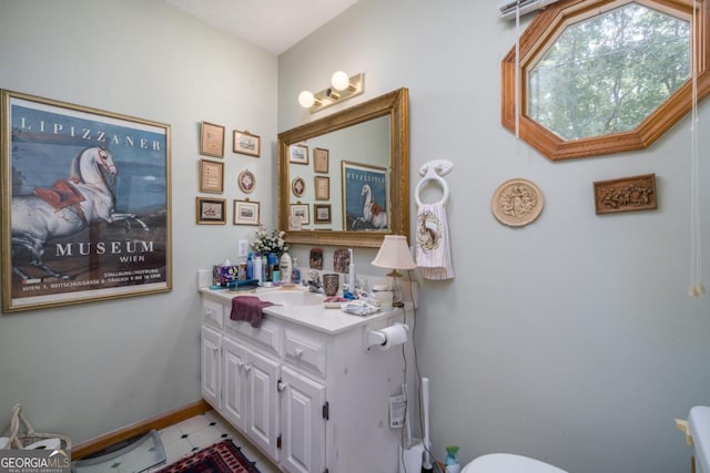 bathroom with vanity and baseboards