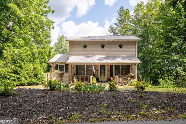 view of front of home with covered porch and metal roof