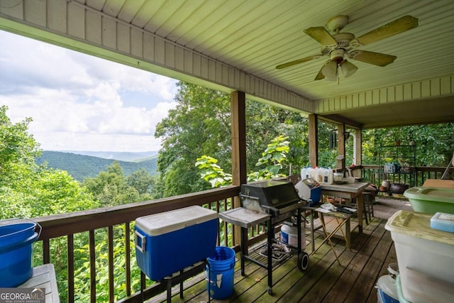 deck with a mountain view and a ceiling fan