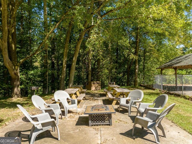 view of patio / terrace featuring an outdoor fire pit and fence