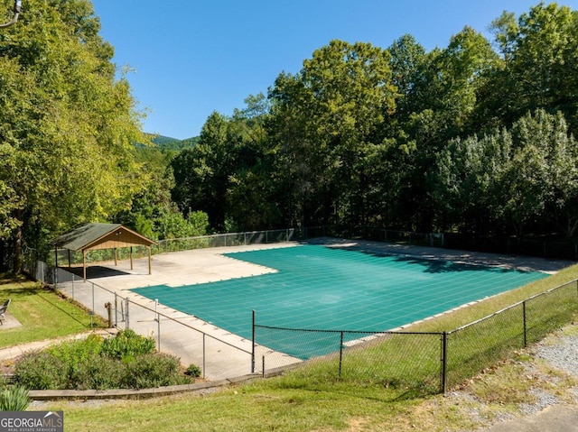 view of pool featuring fence