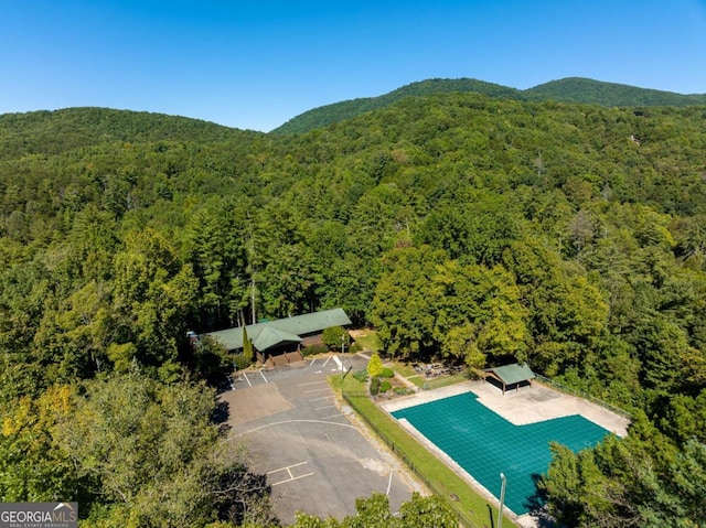 aerial view with a mountain view and a wooded view