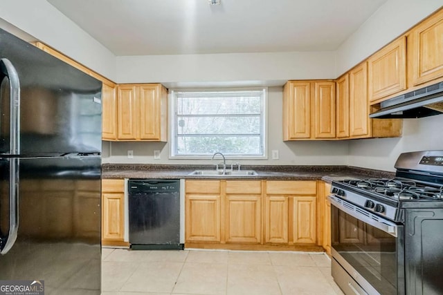 kitchen with dark countertops, black appliances, under cabinet range hood, and a sink