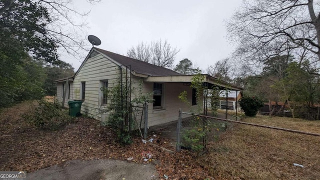 view of side of property with a carport