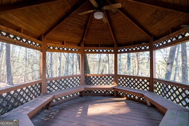 wooden terrace featuring ceiling fan and a gazebo