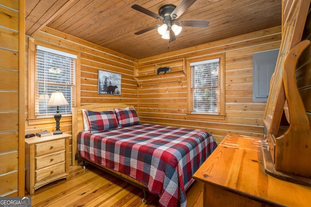 bedroom with wood ceiling, multiple windows, and light wood finished floors