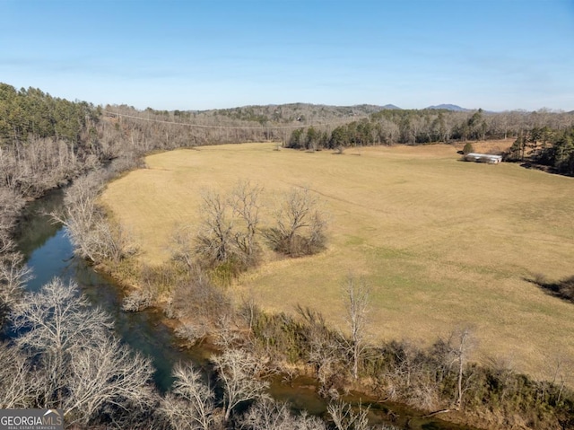 drone / aerial view featuring a water view and a rural view