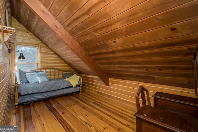 bedroom featuring vaulted ceiling, wood walls, wooden ceiling, and hardwood / wood-style flooring