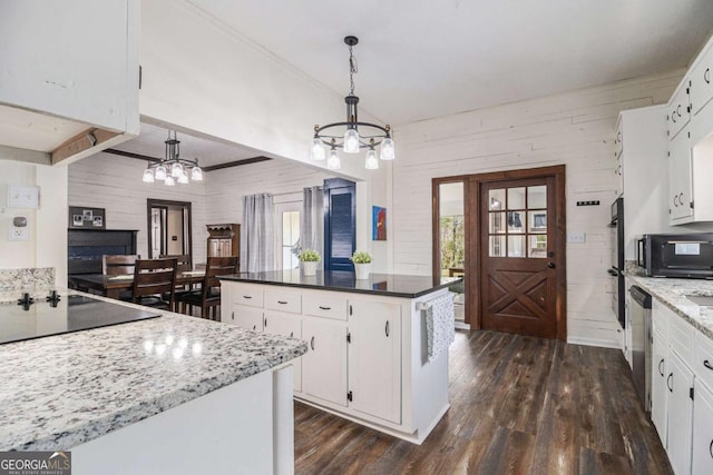 kitchen with hanging light fixtures, plenty of natural light, a kitchen island, and white cabinets