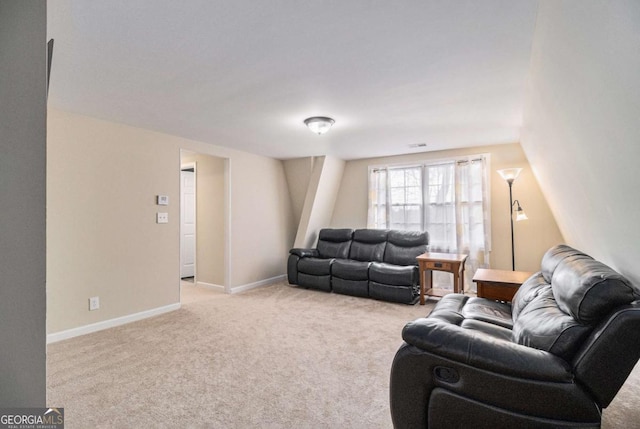 living area with light carpet, visible vents, and baseboards