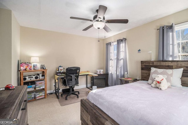 bedroom featuring a ceiling fan, light carpet, and baseboards