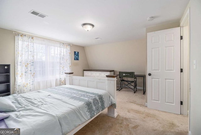 bedroom featuring lofted ceiling, visible vents, and light colored carpet