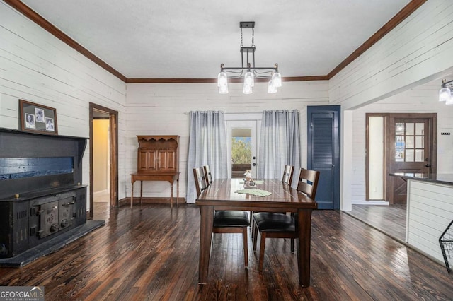 dining space with ornamental molding, dark wood finished floors, and a healthy amount of sunlight