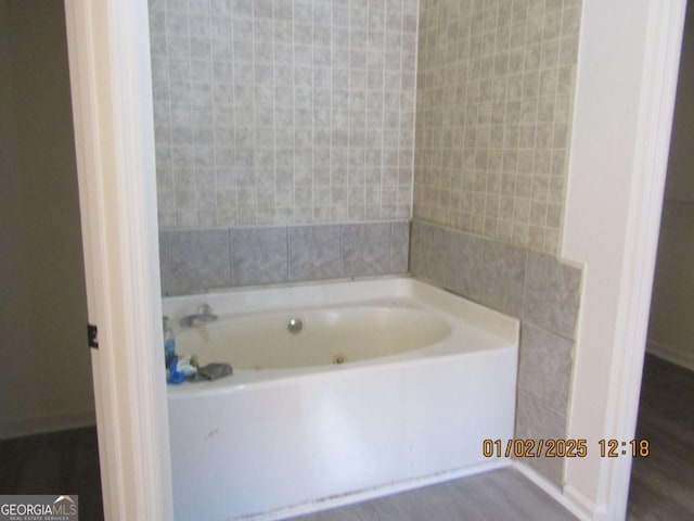 full bathroom with a bath and tile walls