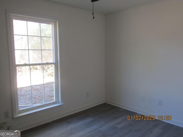 empty room featuring a ceiling fan, baseboards, and wood finished floors