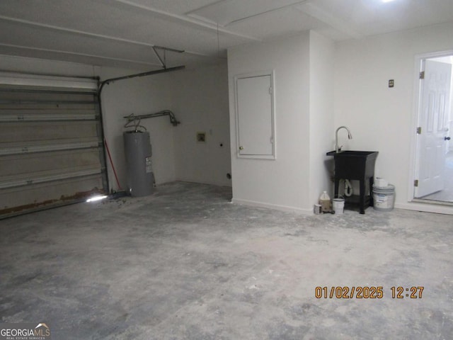 garage with water heater and a sink