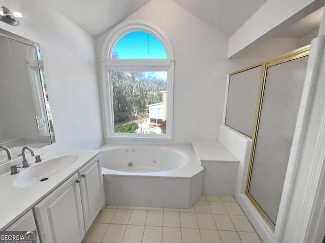 full bath with a stall shower, lofted ceiling, tile patterned floors, a jetted tub, and vanity