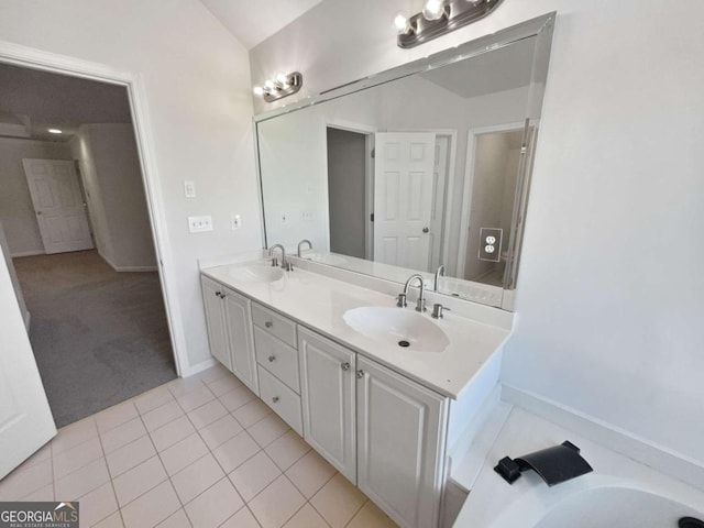 bathroom with tile patterned floors, a sink, and double vanity