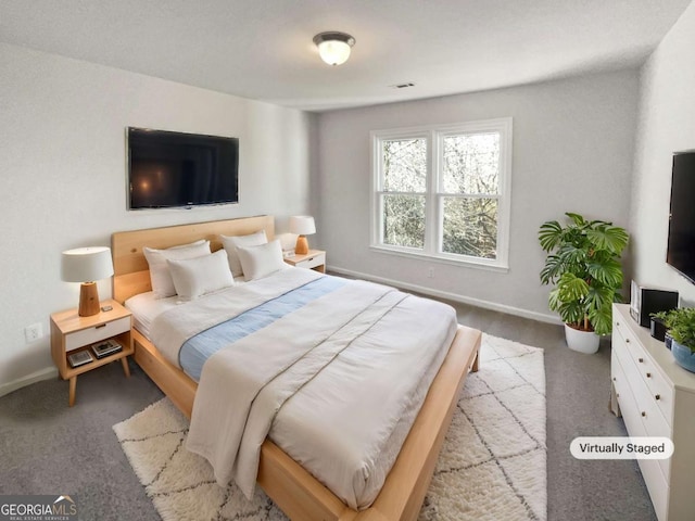 bedroom featuring light colored carpet and baseboards