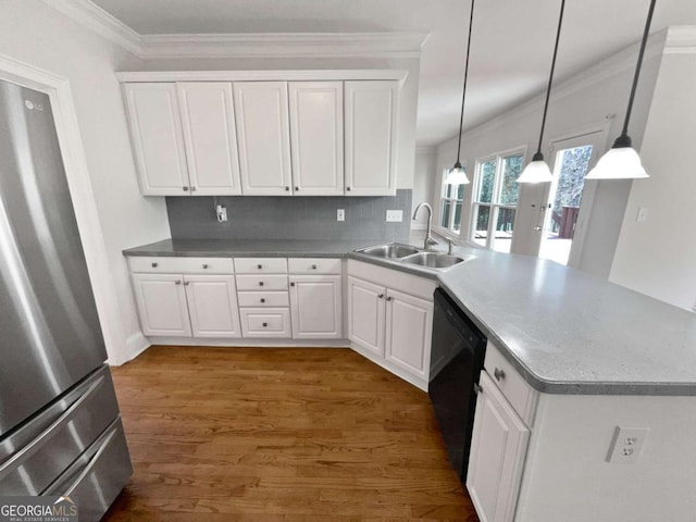 kitchen with black dishwasher, white cabinetry, and a sink