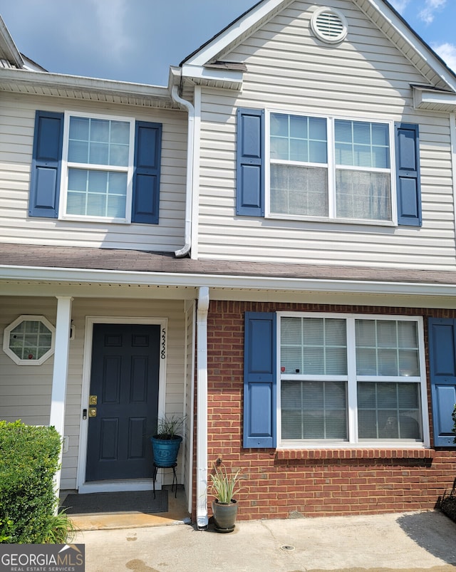 doorway to property with brick siding