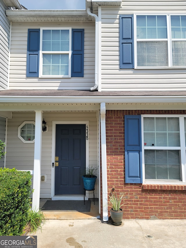 doorway to property featuring brick siding