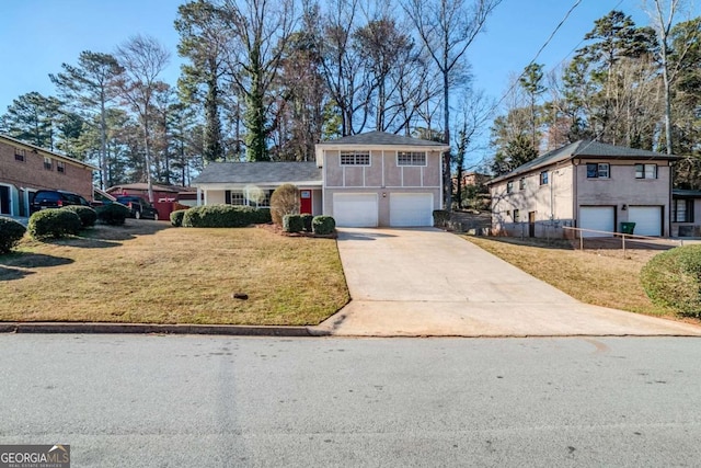 tri-level home featuring an attached garage, a front lawn, and concrete driveway