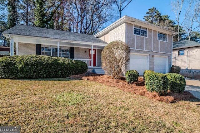 split level home featuring an attached garage, driveway, a front lawn, and brick siding