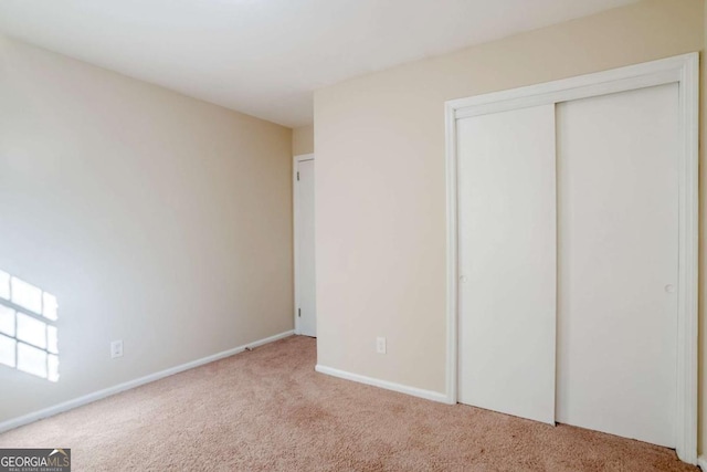 2236 Chestnut Hill Cir, Decatur, GA 30032 - unfurnished bedroom featuring light carpet, a closet, and baseboards