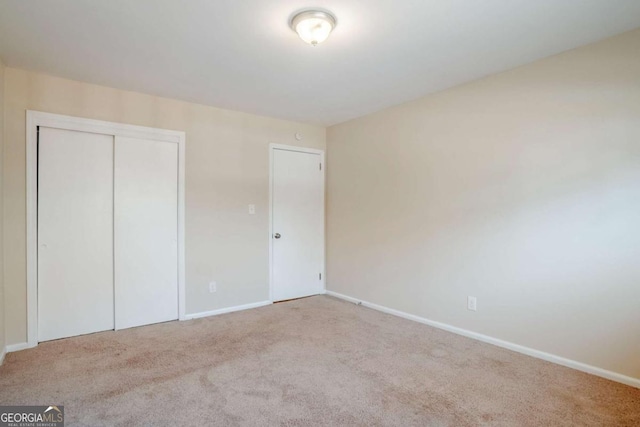 2236 Chestnut Hill Cir, Decatur, GA 30032 - unfurnished bedroom with light carpet, a closet, and baseboards