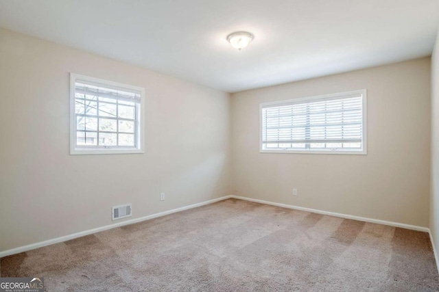2236 Chestnut Hill Cir, Decatur, GA 30032 - empty room featuring a wealth of natural light, visible vents, light carpet, and baseboards