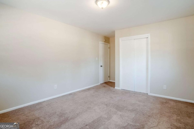 2236 Chestnut Hill Cir, Decatur, GA 30032 - unfurnished bedroom with a closet, light colored carpet, and baseboards