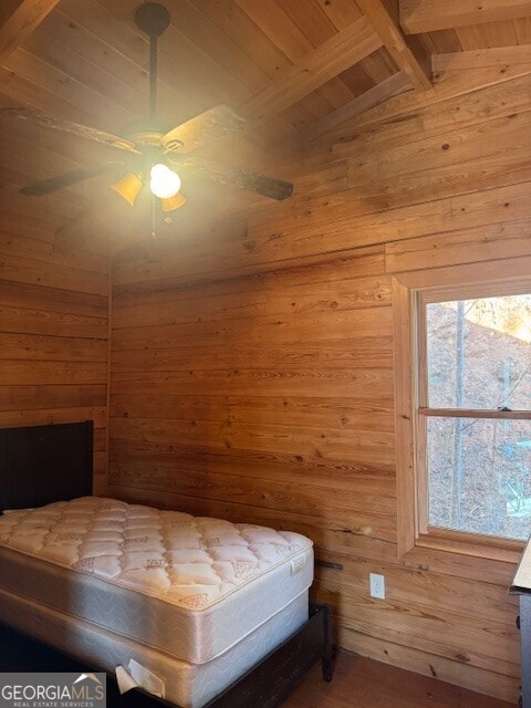 unfurnished bedroom featuring vaulted ceiling with beams, wood walls, wood finished floors, wood ceiling, and a sauna