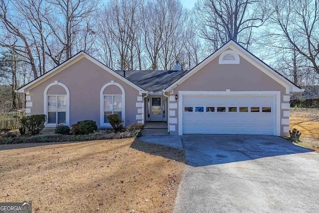 ranch-style house featuring driveway, a chimney, an attached garage, and stucco siding