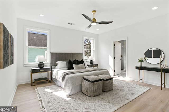 bedroom with light wood finished floors, recessed lighting, visible vents, and baseboards