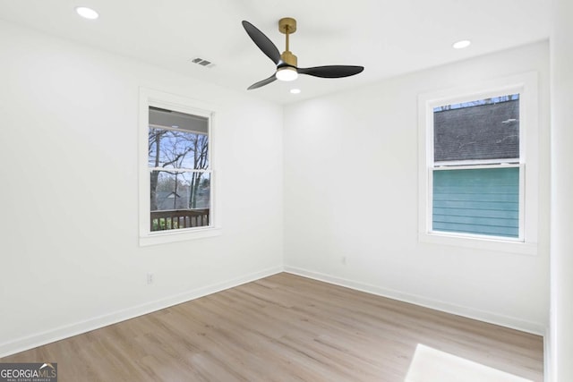 spare room featuring light wood-style flooring, visible vents, baseboards, and recessed lighting