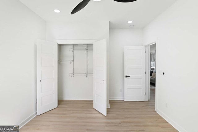 unfurnished bedroom with light wood finished floors, a closet, recessed lighting, and baseboards