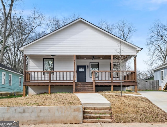 bungalow featuring covered porch and fence