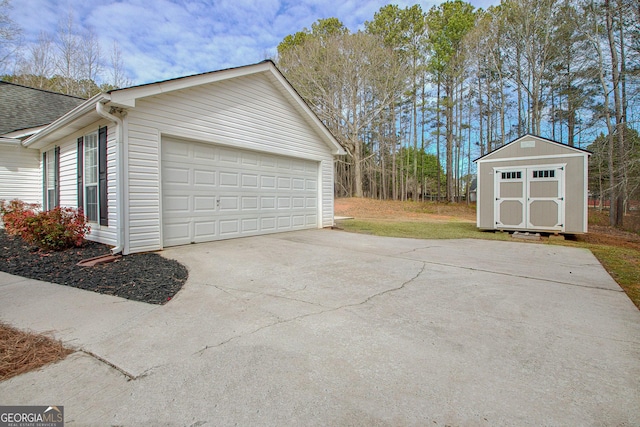 garage featuring a storage unit and concrete driveway