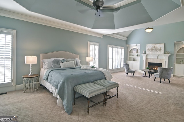 carpeted bedroom featuring visible vents, a warm lit fireplace, crown molding, and vaulted ceiling