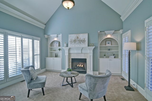 living area with built in shelves, visible vents, high vaulted ceiling, a fireplace, and light colored carpet