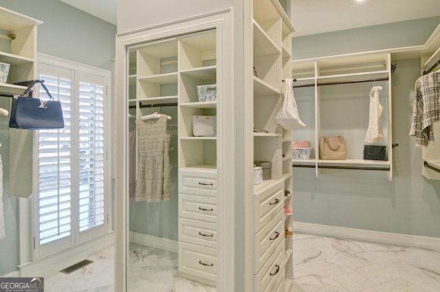 spacious closet with visible vents and marble finish floor