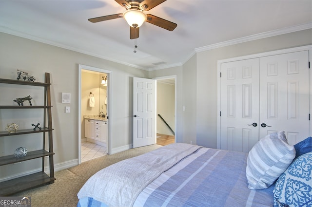 bedroom featuring crown molding, ceiling fan, baseboards, light carpet, and a closet