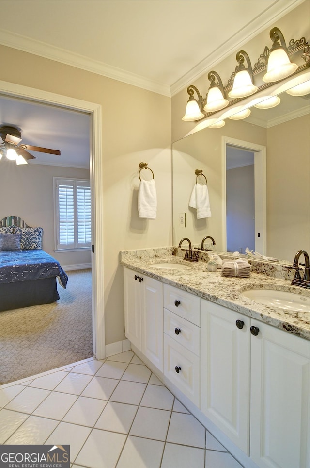 ensuite bathroom featuring a sink, ensuite bathroom, crown molding, and tile patterned flooring