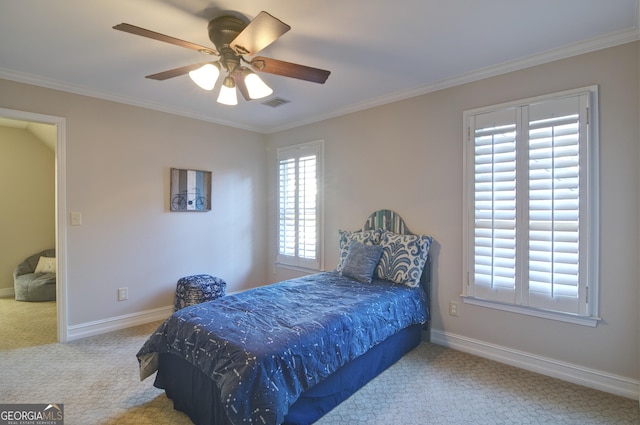 carpeted bedroom with crown molding, multiple windows, baseboards, and visible vents