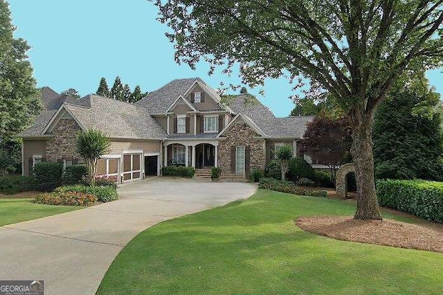 view of front of property with concrete driveway and a front yard