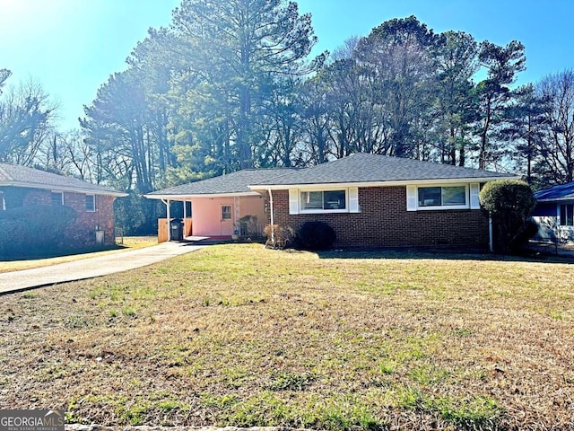 ranch-style house with brick siding and a front yard