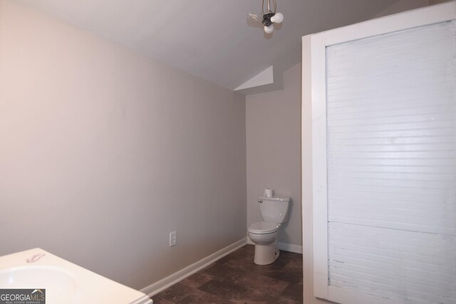 4011 Florida Ave, Atlanta, GA 30360 - half bathroom with vaulted ceiling, toilet, and baseboards