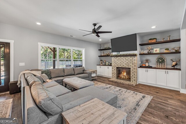 living room with ceiling fan, recessed lighting, a fireplace, visible vents, and dark wood-style floors