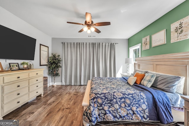 bedroom with visible vents, wood finished floors, and a ceiling fan